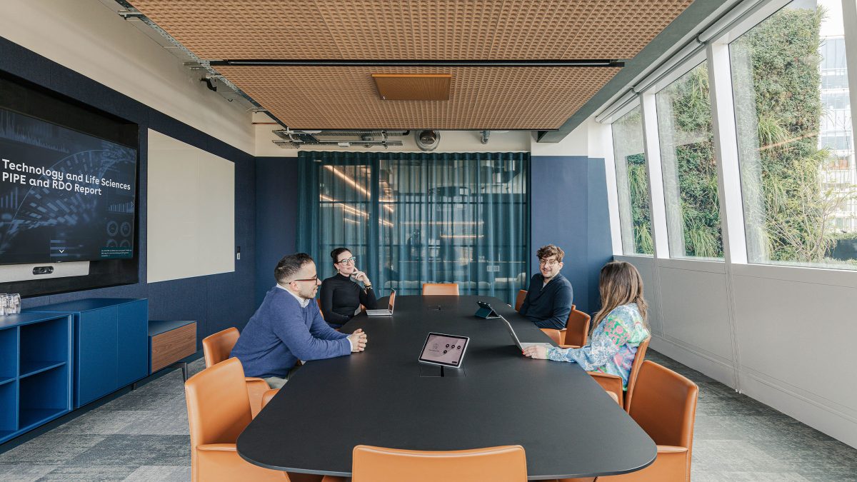 four-people-sitting-in-boardroom-at-wilson-sonsini-london-office