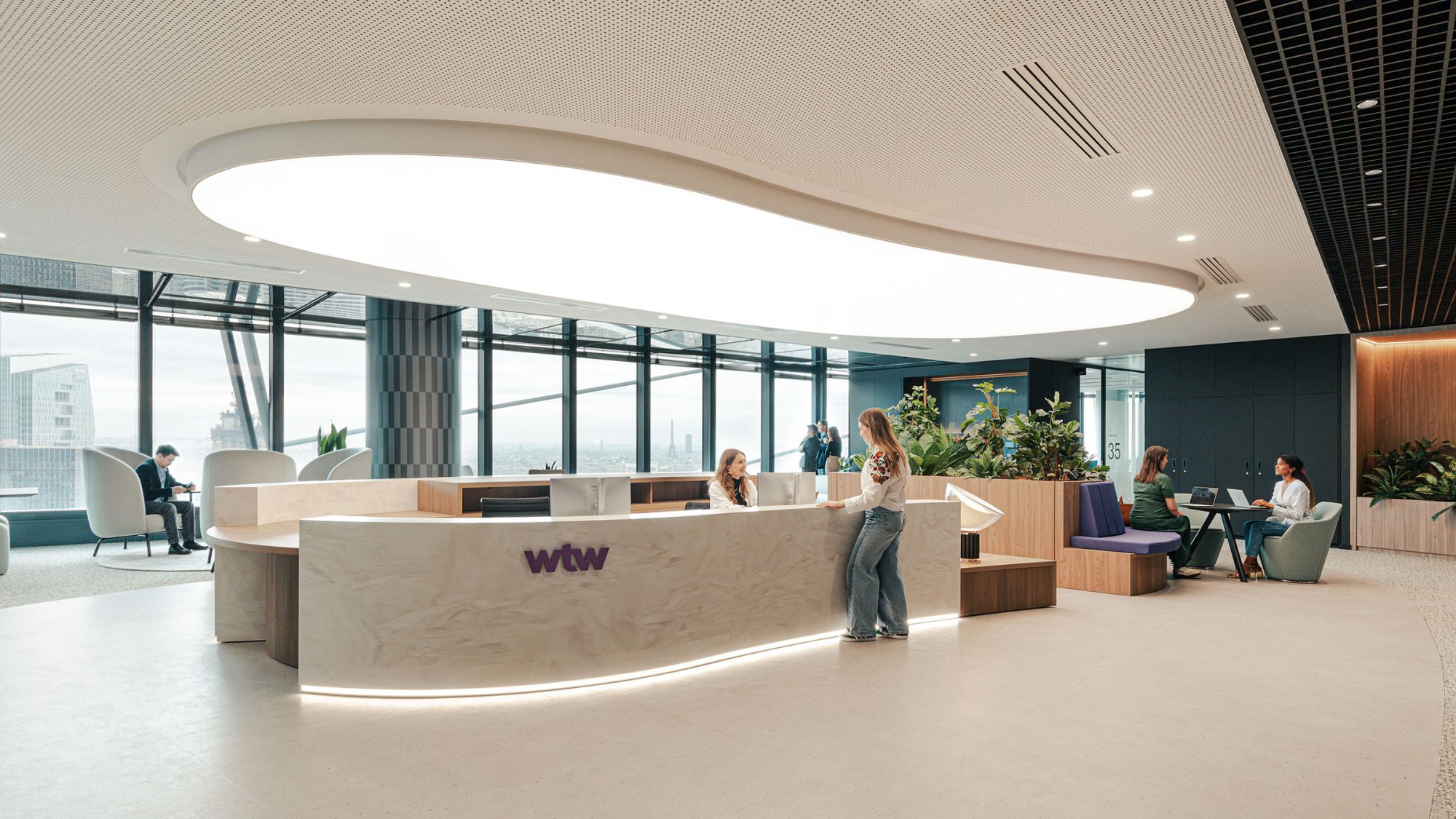 large-arrival-lounge-with-logo-on-reception-desk-at-wtw-paris-office