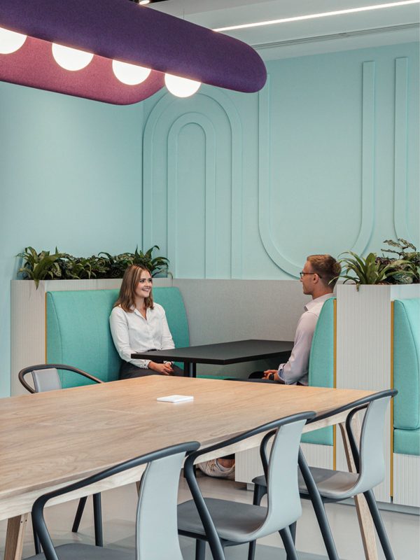 two-people-sat-in-a-pastel-green-booth